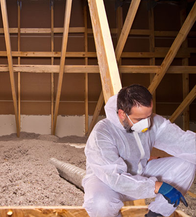 Insulation Contractor Inspecting Cellulose Insulation in Attic Fiberlite